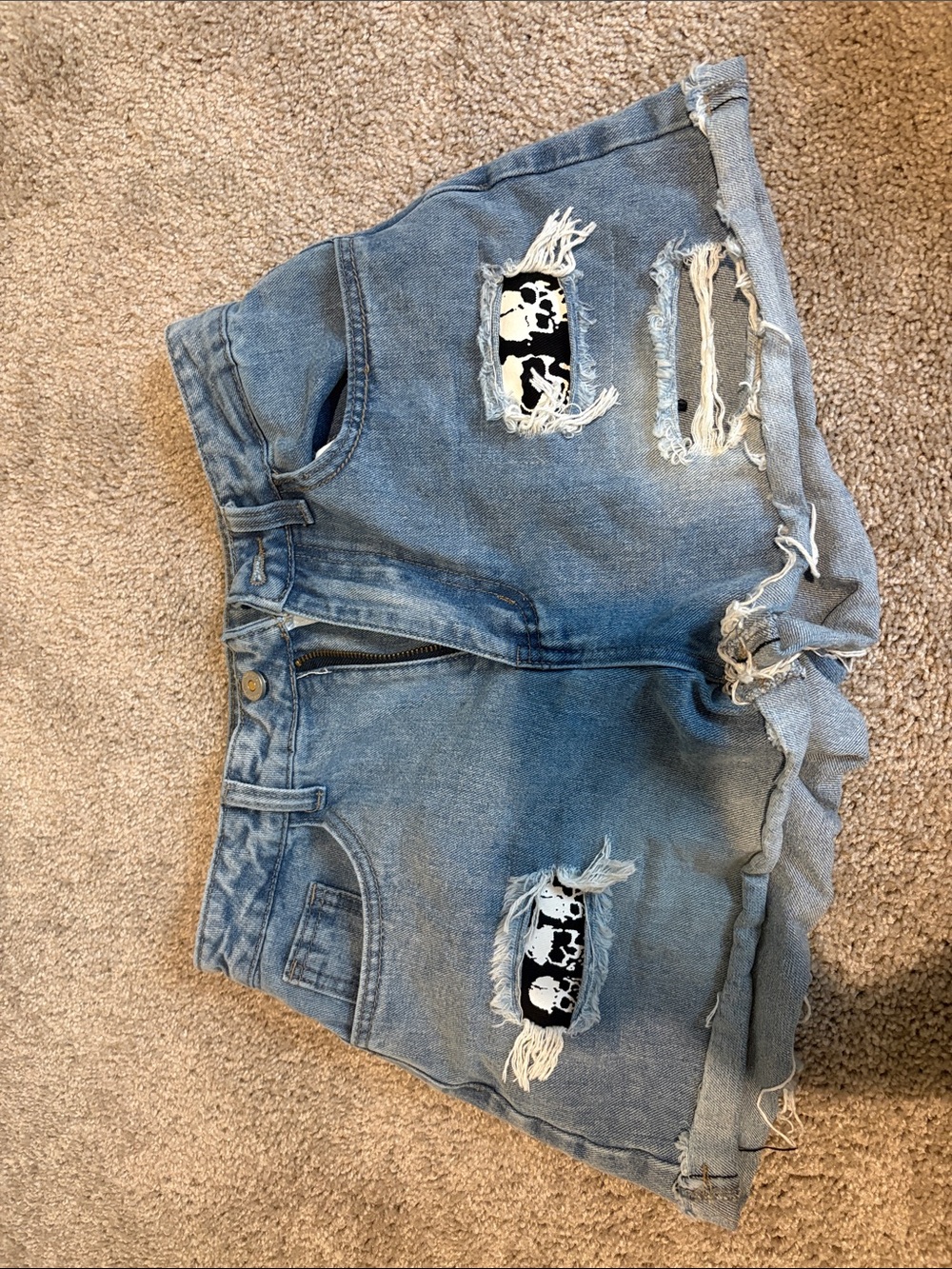 ROMWE Light Blue Ripped Denim Shorts with Skull Patch Accents